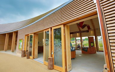 A wooden building with wide open doors