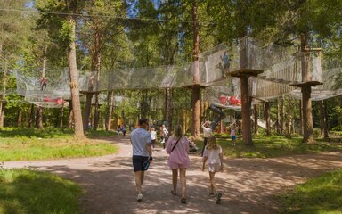A family walking towards the Nets enclosure at Alice Holt Forest