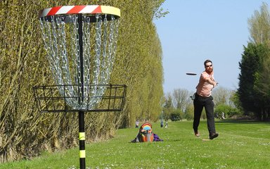 Man playing disc golf in a park