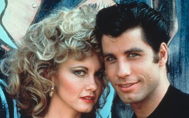 John Travolta as Danny Zuko and Olivia Newton John as Sandy Olsson in Grease. 