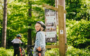 Kid on bike in forest