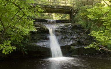 Waterfall under a bridge