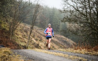 Runner on forest trail 