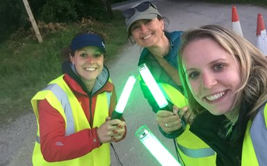 Three women with glow sticks in hand