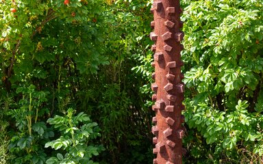A patina iron sculpture based on the tread of a bike tyre