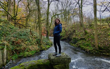 Tiffany Francis-Baker stood next to stream in the forest