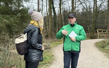 Man and woman talking in a forest setting