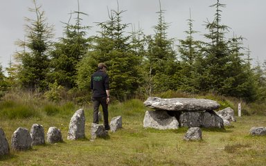 A ranger walking through historic site at Bellever