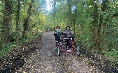 Two women sharing an adaptive bike on the family cycle trail