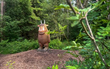 A sculpture of the Gruffalo in the forest