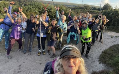 Group os nordic walkers on top of a hill