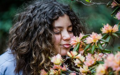 Girl smelling flower