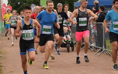 People running towards the camera as they set off on a 10K run