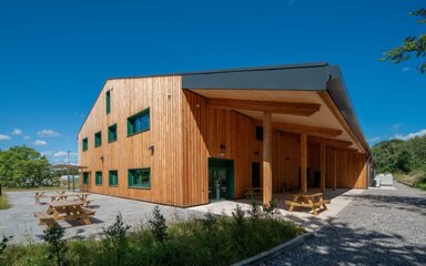 A modern timber building on a sunny day.