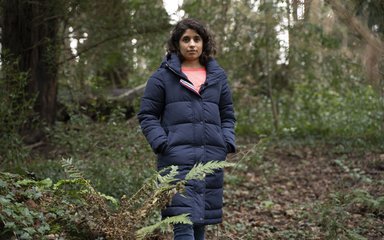 Meera, Head of Partnerships, standing in the forest