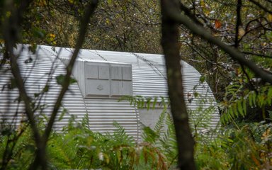 Nissen Hut sculpture through the trees