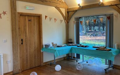 an interior shot of an oak framed building set up for a party