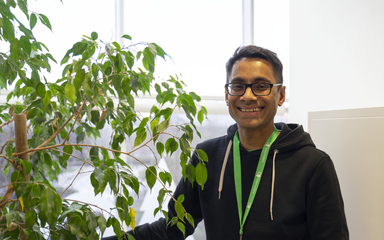 Forestry England staff member stood by tree smiling