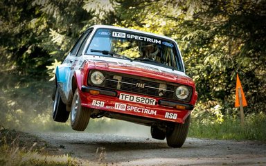 Car flying through the air at track racing event