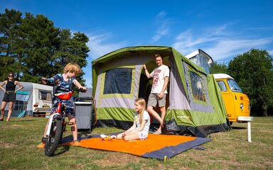 Family camping at Rendlesham Campsite with green tent