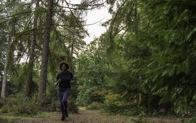 Woman running on forest path