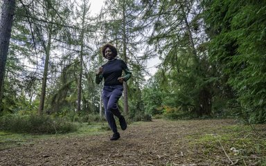 Woman running on forest path