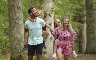 A family of four walking in Salcey Forest