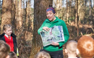 Forestry England ranger speaking to a group of children