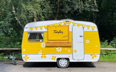 Dapheney's Toasties yellow and white caravan, catering partner at Thieves Wood