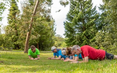 Group of people exercising in the forest