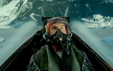 Maverick, played by Tom Cruise, performs a maneuver in a fighter jet plane. 