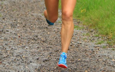 Runner's feet on a woodland path