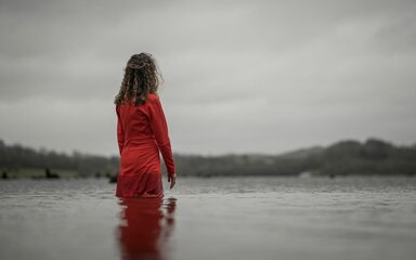 woman in red standing in a lake