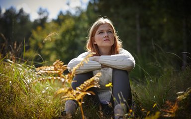 Woman sat being calm in the forest