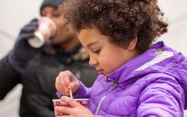 Young girl stirring a cup of hot chocolate