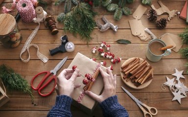 Wrapping a christmas present with decorations