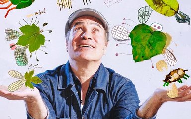 An image of author Yuval Zommer looking up to see his artwork of bugs dancing around him