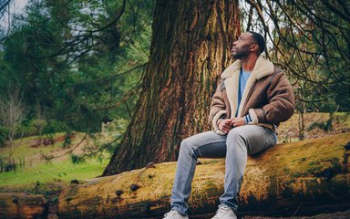 Man sitting on trunk