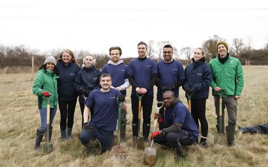 group of people with digging tools in a field