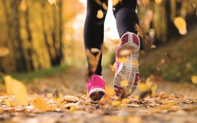 runner in autumn through woodland