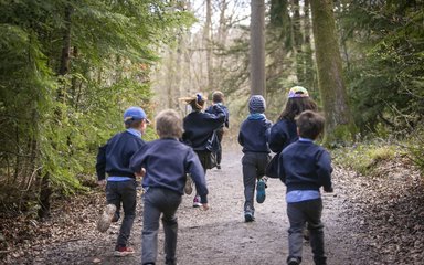 Children school running through forest