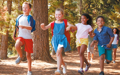 Children running through the forest