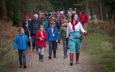 Theatrical captain leading a group of visitors