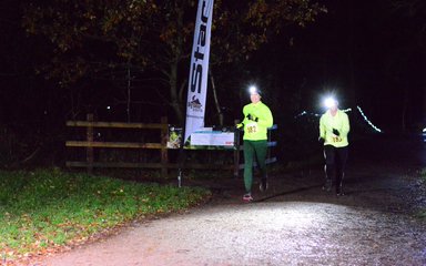 Runners in the forest with head torches on