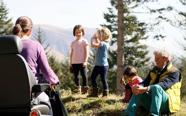 Family with a tramper in the forest