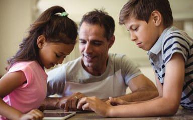 Father and kids using tablet