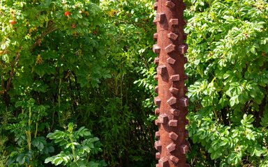 A patina iron sculpture based on the tread of a bike tyre.