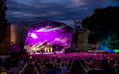 Music concert stage with crowd in front at night
