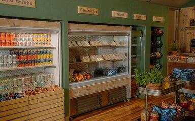 Fridge and hot food displays of drinks, sandwiches, fruit and snacks