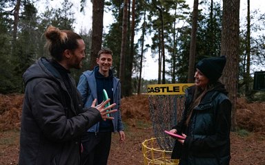 Disc golf group at basket